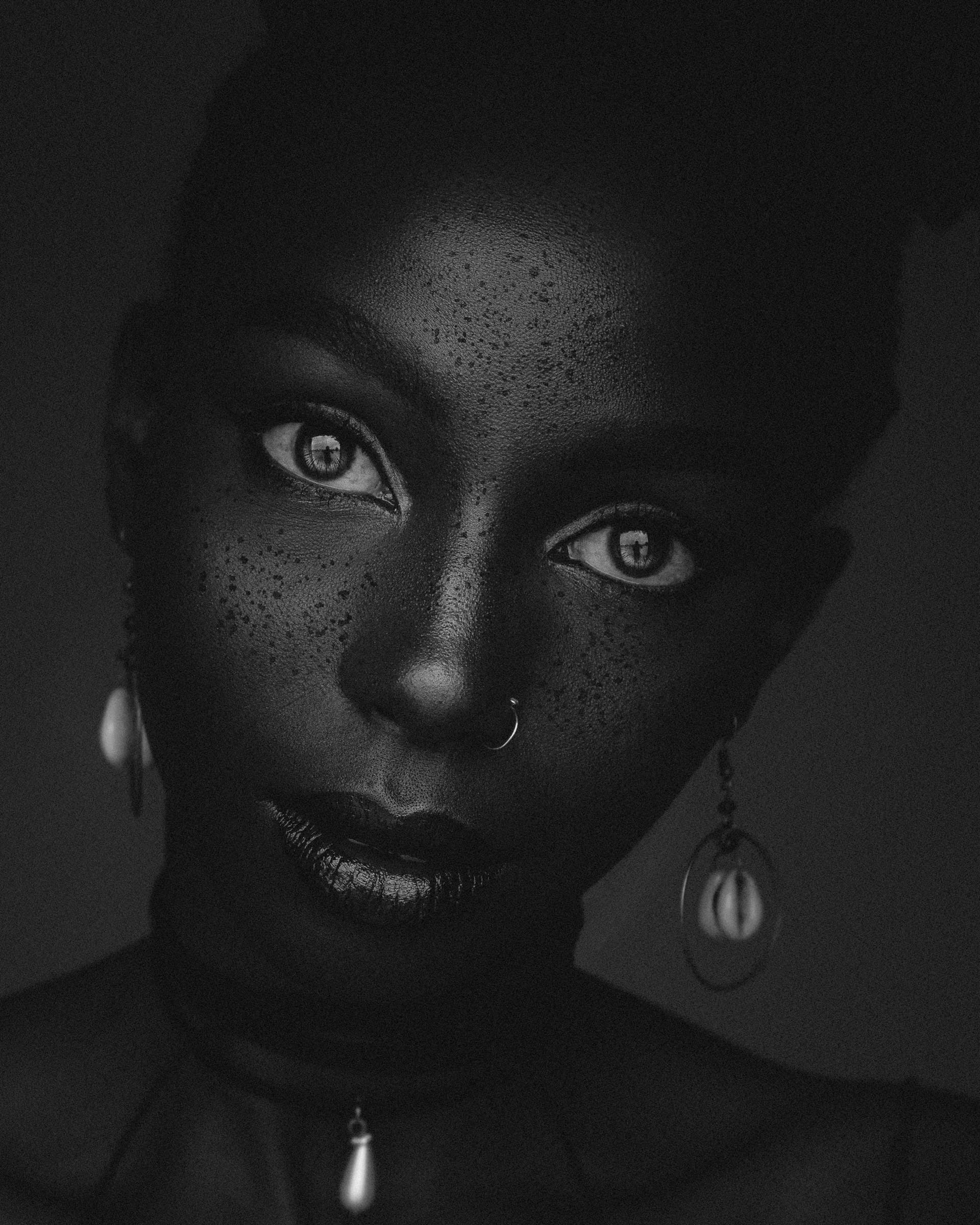 A close portrait of a woman looking into the camera.